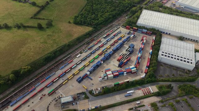 Aerial view of Daventry International Rail Freight Terminal with colorful shipping containers and freight trains at the logistics hub in Kilsby, England, United Kingdom.