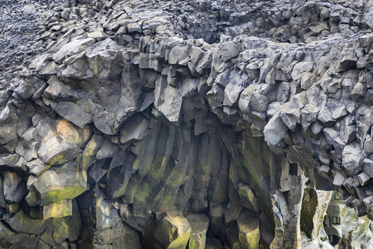 View of the dramatic basalt columns and volcanic rock formations at the South Coast, Dyrholaey, Myrdalshreppur, Iceland.