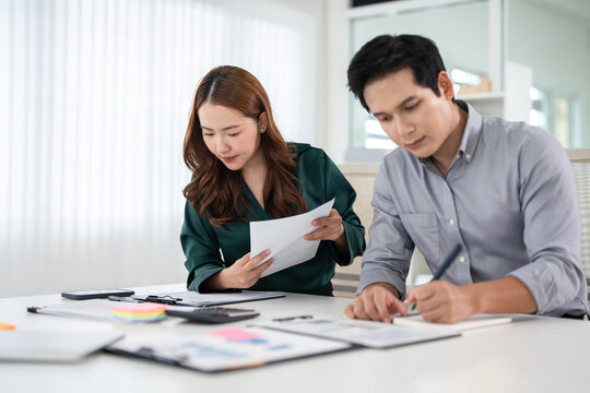 Asian Businesspeople working with papers for planning, financial analysis and chart.  discussion in boardroom for investment, risk management or budget report.