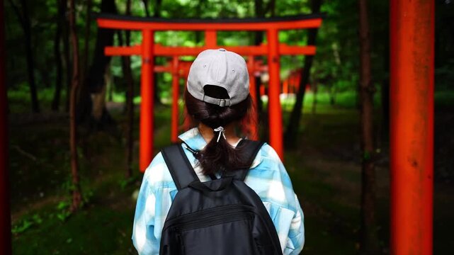 Woman Walking Through Torii Gates at Kashihara Jingu Shrine Japan