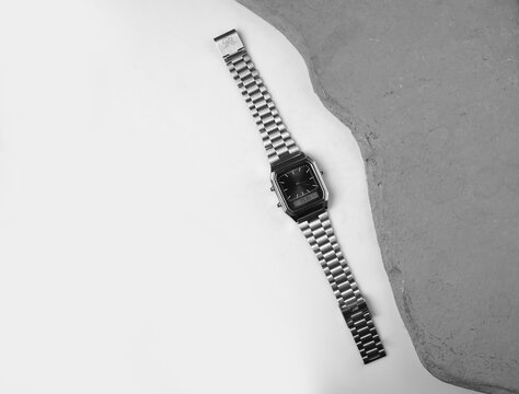 Silver Analog Digital Wristwatch Flat Lay on Minimalist Monochrome Background with Gray Concrete Texture and Copy Space