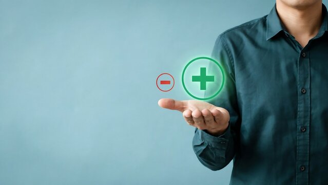 Man holding glowing plus sign and minus icon above palm for business growth and decision making