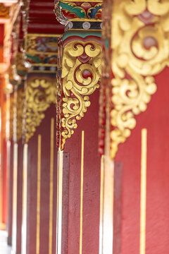 View of the ornate red and gold pillars with intricate traditional carvings at Namobuddha Monastery in Simalchaur Syampati, Bagmati Province, Nepal.