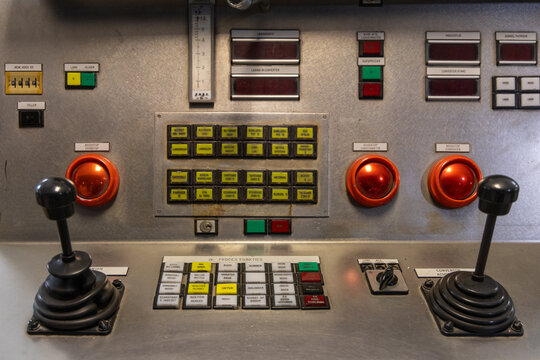 View of an industrial control panel with joysticks, buttons, and switches for machinery operation in Velsen-Noord, North Holland, Netherlands.