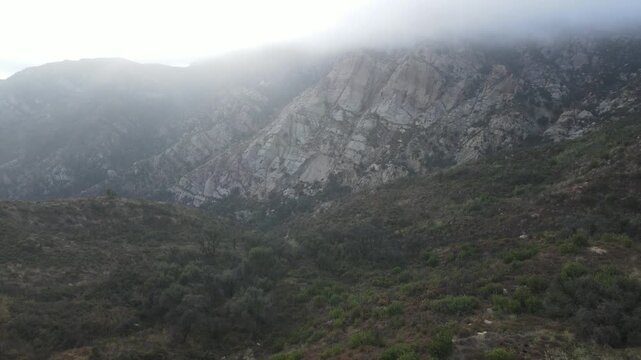 Rocky mountainside under a ceiling of low cloud