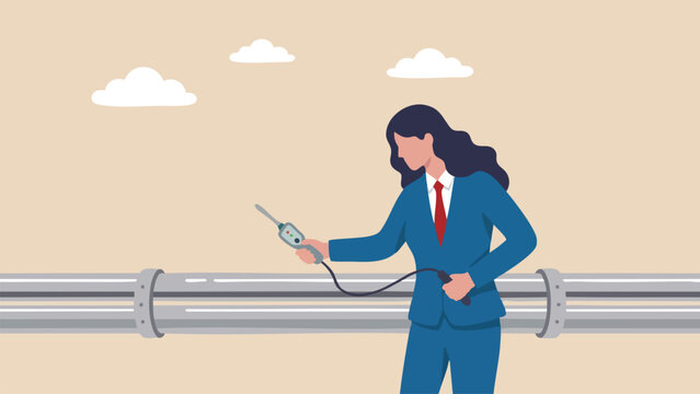 Businesswoman using a handheld device to inspect a long metal pipeline for maintenance