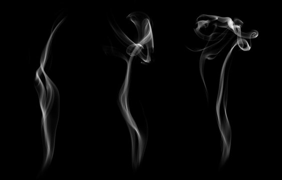 Set of three elegant white incense smoke wisps swirling upward on a black background. Concept of spiritual atmosphere, mindfulness meditation, aromatherapy, and abstract vapor overlay.