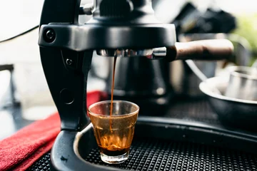 Manual lever espresso machine extracting a fresh shot of coffee. © artrachen