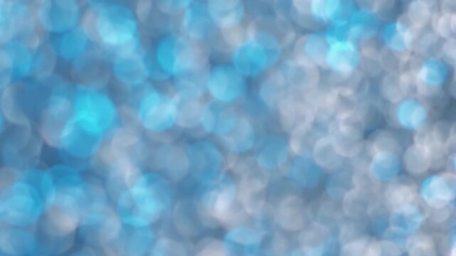 Glitter bubbles illumination. Blur confetti light. Gray silver blue flare leak defocused beam reflection. Colorful bokeh abstract flicker background.