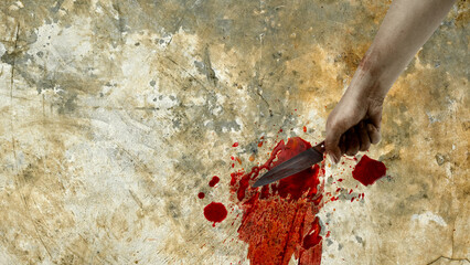 A close-up shot of a human hand holding a bloody knife against a stained, textured wall, evoking themes of crime, thriller, and horror. Spooky Halloween horror background © Leo Lintang