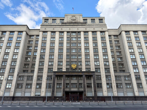 Moscow, Russia - August 9, 2026: frontal view of State Duma parliament building on Okhotny Ryad street with Russian coat of arms and monumental facade
