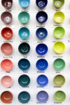 Display of colorful ceramic bowls with descriptive color labels