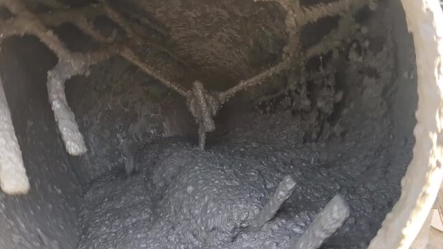 Close Up Inside View of Rotating Concrete Mixer Drum Mixing Wet Cement Mixture