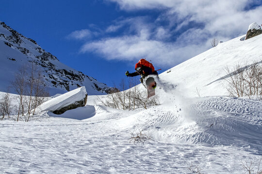 Snowboarder catching air on a sunny day