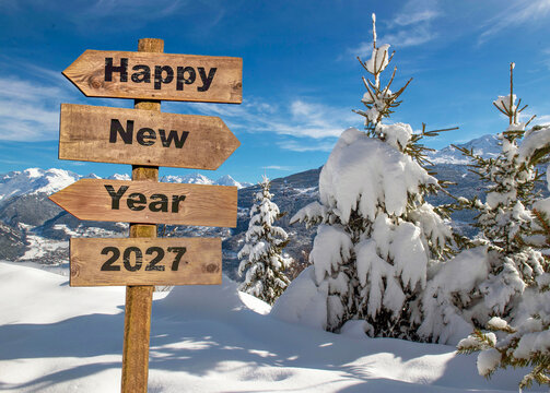 2027 happy new year written on wooden postsign  in  snowy alpine mountain with firs covered with fresh snow