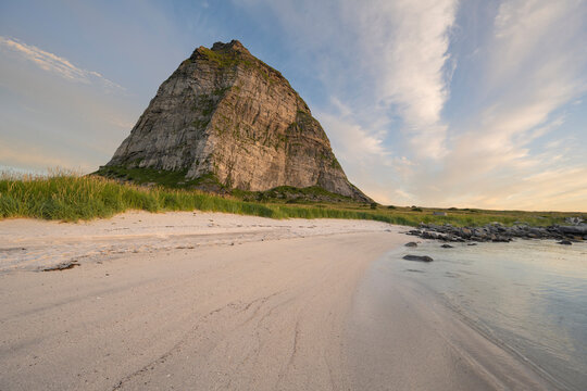 Tr&aelig;nstaven mountain peak rises over small sandy beach, Sanna