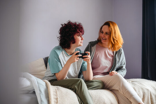 Parent and teenager sharing a fun gaming experience at home