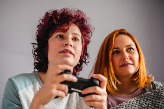 Mother and teenage daughter enjoying digital entertainment together