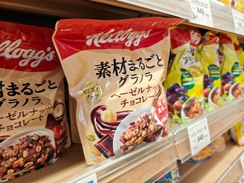 Kellogg's packaged granola and breakfast cereal products are displayed for sale on a retail store