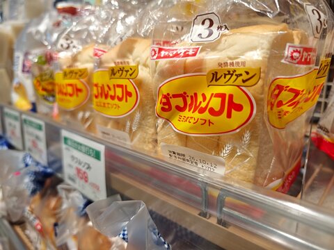 Packaged sliced bread from Japanese food manufacturers is displayed for sale on supermarket shelves