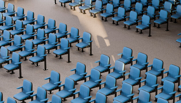 Blue chairs in empty auditorium arranged in rows