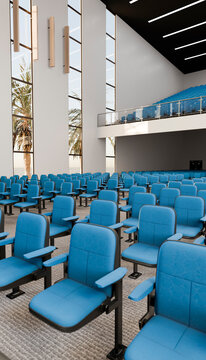 Empty auditorium with blue chairs and balcony seating