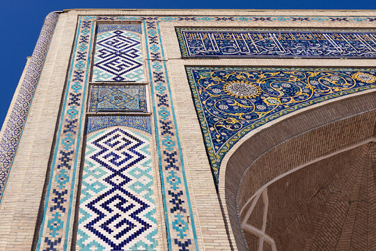 Ornate tilework facade of Barak Khan Madrasah in Tashkent featuring geometric mosaics and floral arabesque patterns. Ideal for travel publications, cultural heritage projects, and architectural.