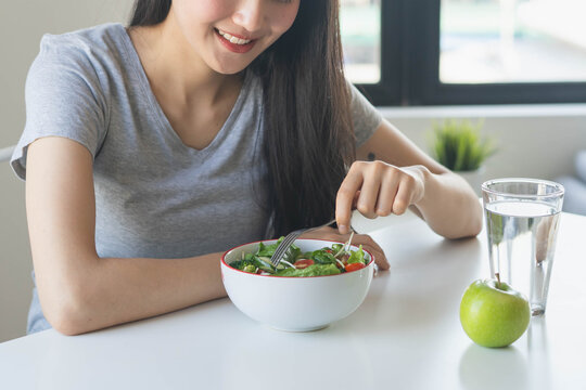 eat healthy food on wellness lifestyle. Beauty young woman eating salad as a breakfast.