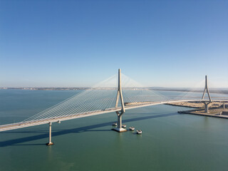 Aerial drone view of the suspension bridge and coastal bay in Cadiz, Spain © Nikolay