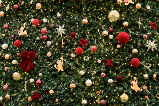 Full frame background of a lush Christmas tree with ornaments