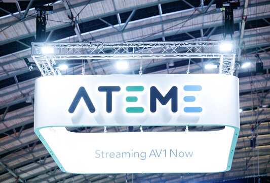 Amsterdam, Netherlands - September 12, 2026: Ateme exhibition booth with illuminated overhead sign and streaming AV1 message at IBC media and technology trade show