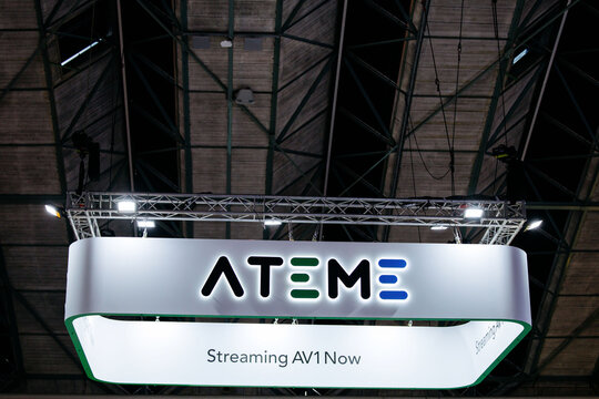 Amsterdam, Netherlands - September 12, 2026: ATEME exhibition sign with streaming AV1 message beneath illuminated truss at IBC, a leading media and technology event display