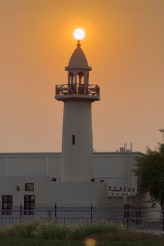 Doha, Qatar - August 10, 2026: Silhouette of Minarte aligned with the glowing sunset sun, dramatic golden sky sunset view. wakrah Qatar
