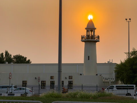 Doha, Qatar - August 10, 2026: Silhouette of Minarte aligned with the glowing sunset sun, dramatic golden sky sunset view. wakrah Qatar