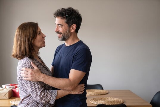 Couple sharing an affectionate embrace at home