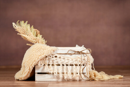 Newborn digital backdrop with empty white wooden box and makramee garland on brown background