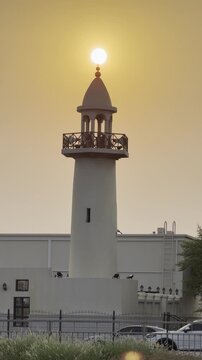 Doha, Qatar - August 10, 2026: Silhouette of Minarte aligned with the glowing sunset sun, dramatic golden sky sunset view. wakrah Qatar