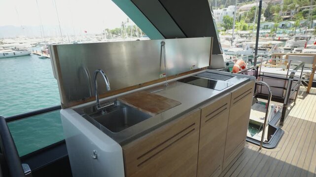 Luxury Yacht Outdoor Galley with Sink, Stove and Countertop on Sunny Summer Day