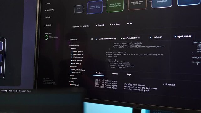 Close-up of a computer monitor displaying programming code and an AI agent workflow orchestration dashboard with terminal logs running in a dark room