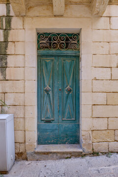 Teal Green Entrance Door with Diamond Raised Panels and Wrought Iron Scrollwork