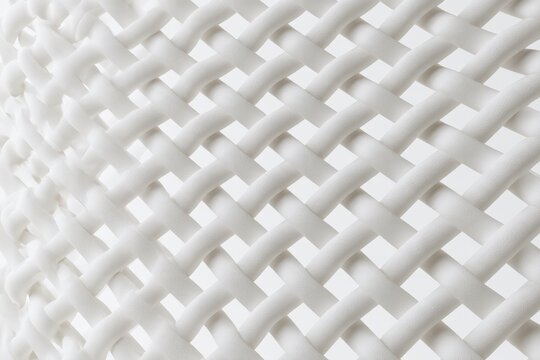 Intricate white lattice pattern with soft shadows on white background