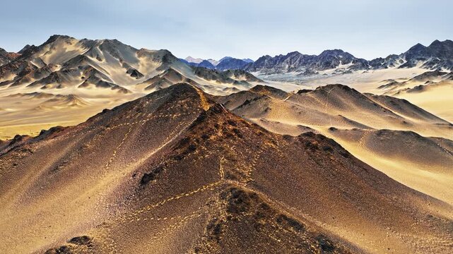 High-angle shot showcases the rugged black desert of Heidu Mountain in Qinghai, featuring dark rocky ridges and sand dunes.