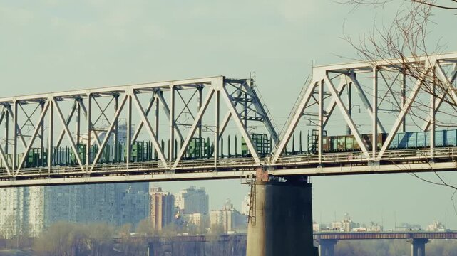 Freight Train Crossing Steel Truss Bridge Over River