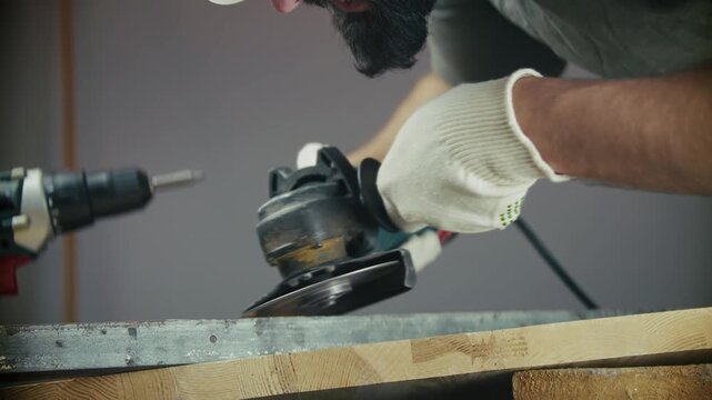 Worker Using Angle Grinder On Metal Beam During Construction And Woodworking