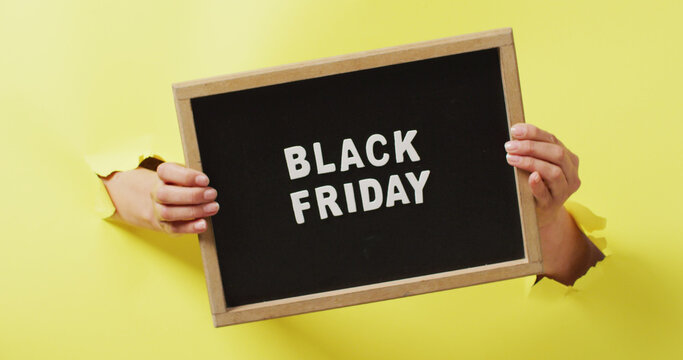 Digitally generated image depicts a Black Friday sale announcement on a yellow backdrop.