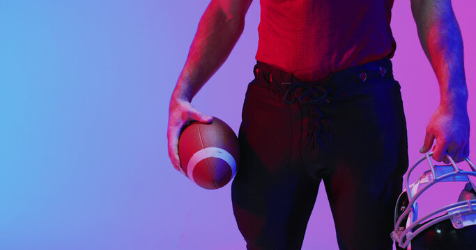 Image of caucasian american football player with copy space over neon purple background
