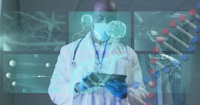 Doctor analyzing digital medical data on tablet, wearing mask in modern lab