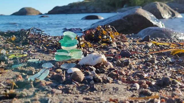 Stacked Sea Glass on Rocky Beach by the Water