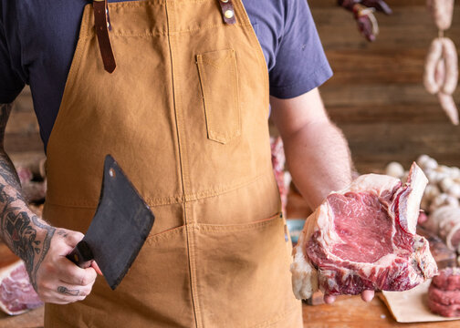 Butcher displaying fresh meat cuts.
