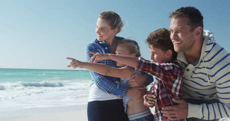 Smiling caucasian couple with son and daughter on beach by seaside, copy space © WavebreakMediaMicro